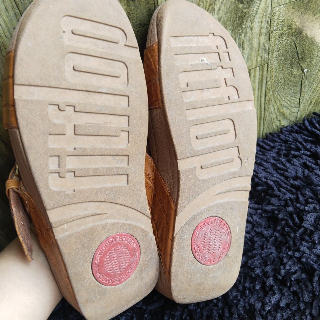 FitFlop Brown Crocodile Embossed Cross Strap Sandals (Category: Flats & Sandals) located in Lubao. Submitted by dione_closet503 (Listing ID 1469941841, Image 3). Description: - Brand: FitFlop - Color: Tan brown - Pattern: Crocodile embossed - Style: Easy slip-on slide sandals with cross straps - Details: Gold tone metal decorative buckles - Comfort: Cushioned footbeds for all-day support - Perfect for: Warm weather and everyday casual wear.