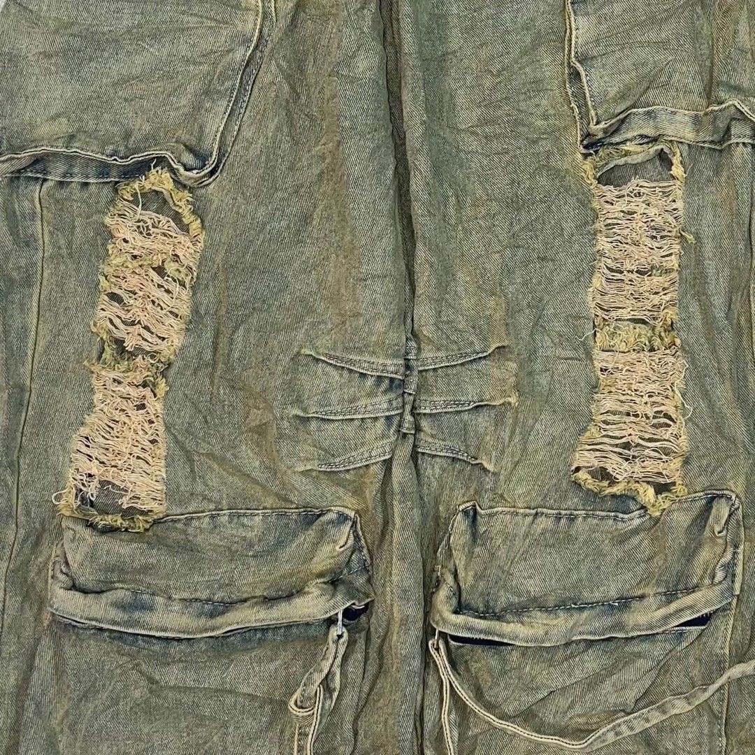 Fivelgene Olive Washed Distressed Cargo Pants (Category: Jeans) located in Davao. Submitted by brigulferic (Listing ID 1469872978, Image 3). Description: - Brand/Model: Fivelgene cargo pants - Color/Wash: Olive washed denim with a unique acid wash finish - Fit: Wide leg style with a high waist, belt loops, and zip fly - Details: Multiple utility pockets featuring button and zipper accents - Condition/Design: Distressed shredded knee patches with 