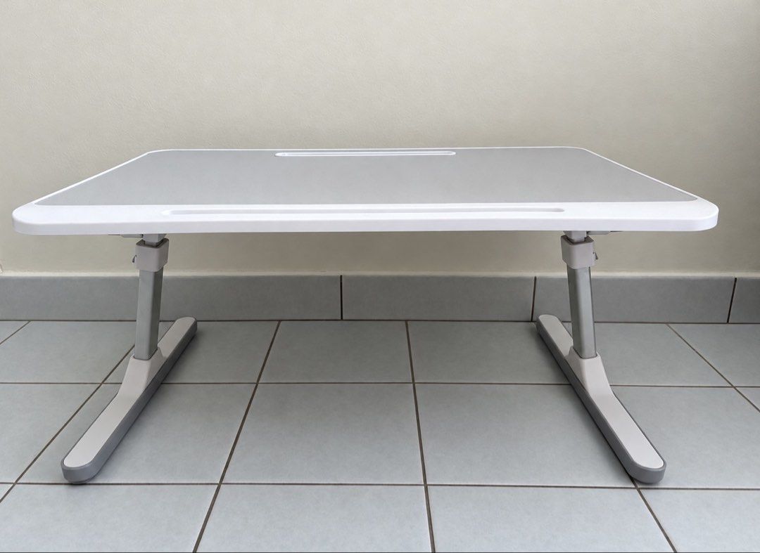 Foldable Table Adjustable height (Category: Tables & Sets) located in Singapore. Submitted by sunnyyflowery (Listing ID 1469766622, Image 2). Description: - can tilt for laptop use or writing - height range 27 cm to 40cm adjustable - table dimension 60cm x 40cm .
