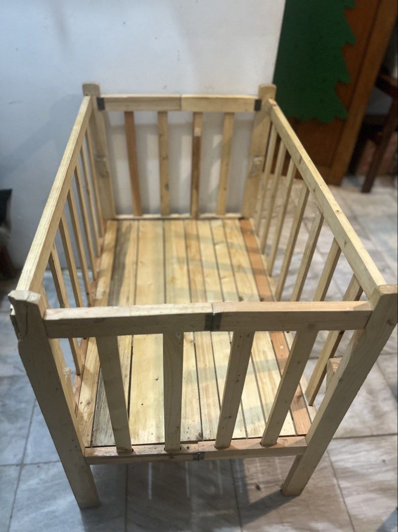 Foldable Wooden Baby Crib Nursery Bed (Category: Cots & Cribs) located in Quezon City. Submitted by jp.summer (Listing ID 1469877413, Image 1). Description: - Solid wooden baby crib with a classic natural finish - Features a secure slat design all around with an included slatted base panel - Conveniently folds flat for easy storage when not in use - Issue: there was a chip off sa gilid ng crib when we bought this but failed to return it as this w