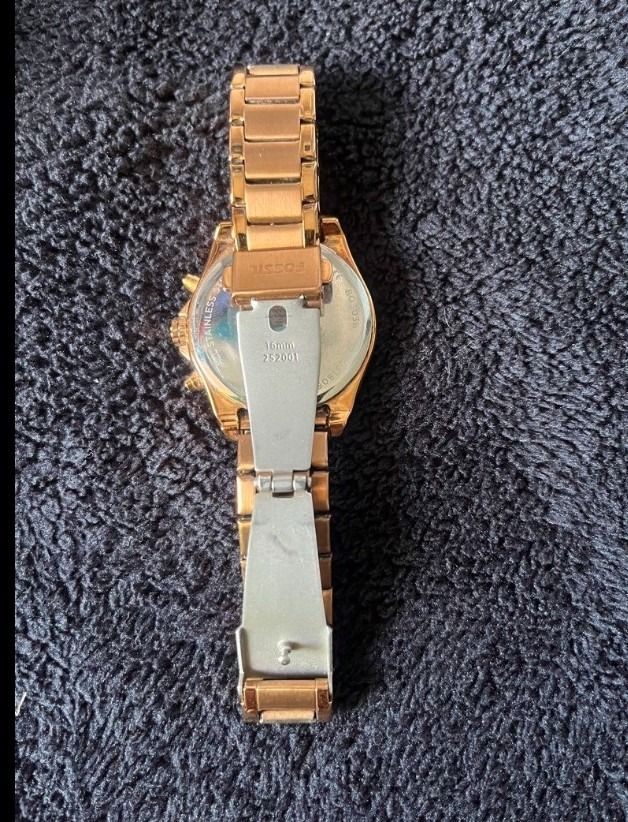 Fossil Rose Gold Chronograph Watch (Category: Women's Watches) located in Real. Submitted by marcomarjo53691 (Listing ID 1469882123, Image 2). Description: - Brand: Fossil - Color: Elegant Rose Gold - Display: Chronograph with 3 sub-dials - Numerals: Classic Roman numerals at 12 and 6 o'clock - Band: Stainless steel link bracelet with secure deployant clasp (16mm sizing) - Model Details: Stamped 252001 on case back and clasp - Condition: Well-mai