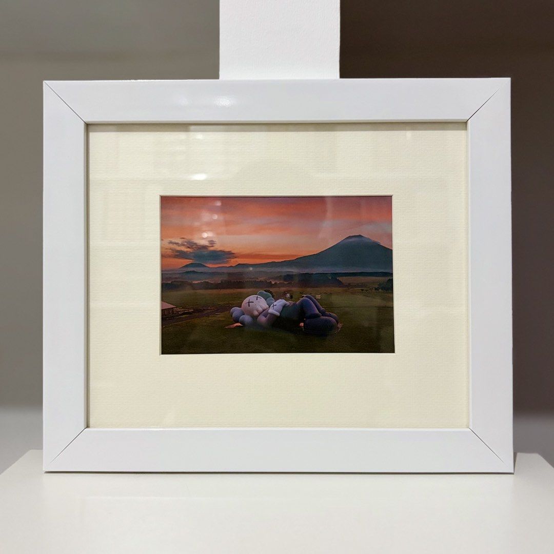 Framed KAWS Postcard “HOLIDAY” (Category: Art & Prints) located in Santa Rosa. Submitted by shikaricollectibles (Listing ID 1469867103, Image 1). Description: Framed KAWS Postcard “HOLIDAY” An art postcard from the merchandisecollection released for the KAWS TOKYOFIRST exhibition in 2021. Postcard Size: 5.9 x 4.15 inches Frame Size: 11.5 x 9.7 inches Frame Thickness: 1 inches Frame Color: White Glazing: Glass Mat Border: 2 Inches Mat Color: Off-w