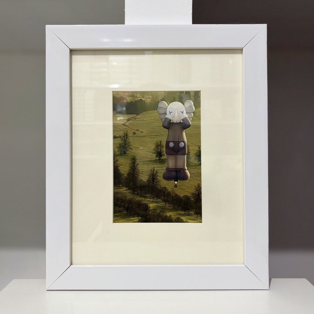 Framed KAWS Postcard “HOLIDAY” (Category: Art & Prints) located in Santa Rosa. Submitted by shikaricollectibles (Listing ID 1469867335, Image 1). Description: Framed KAWS Postcard “HOLIDAY” An art postcard from the merchandisecollection released for the KAWS TOKYO FIRST exhibition in 2021. Postcard Size: 5.9 x 4.15 inches Frame Size: 11.5 x 9.7 inches Frame Thickness: 1 inches Frame Color: White Glazing: Glass Mat Border: 2 Inches Mat Color: Off-