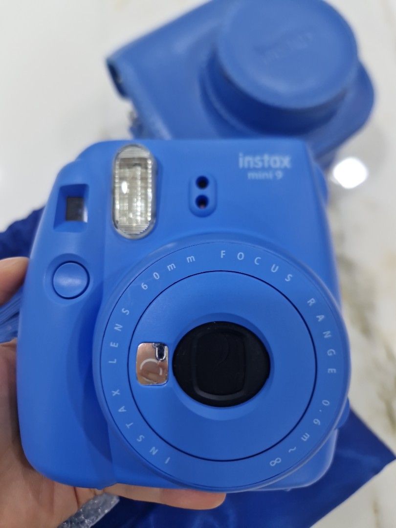 Fujifilm Instax Mini 9 Blue Instant Camera Set (Category: Cameras) located in Quezon City. Submitted by thercor (Listing ID 1469944918, Image 2). Description: Fujifilm Instax Mini 9 Instant Camera - Cobalt Blue - Includes matching blue leatherette carry case, blue drawstring dust bag, and adjustable strap - Includes close-up lens attachment in wrapper.