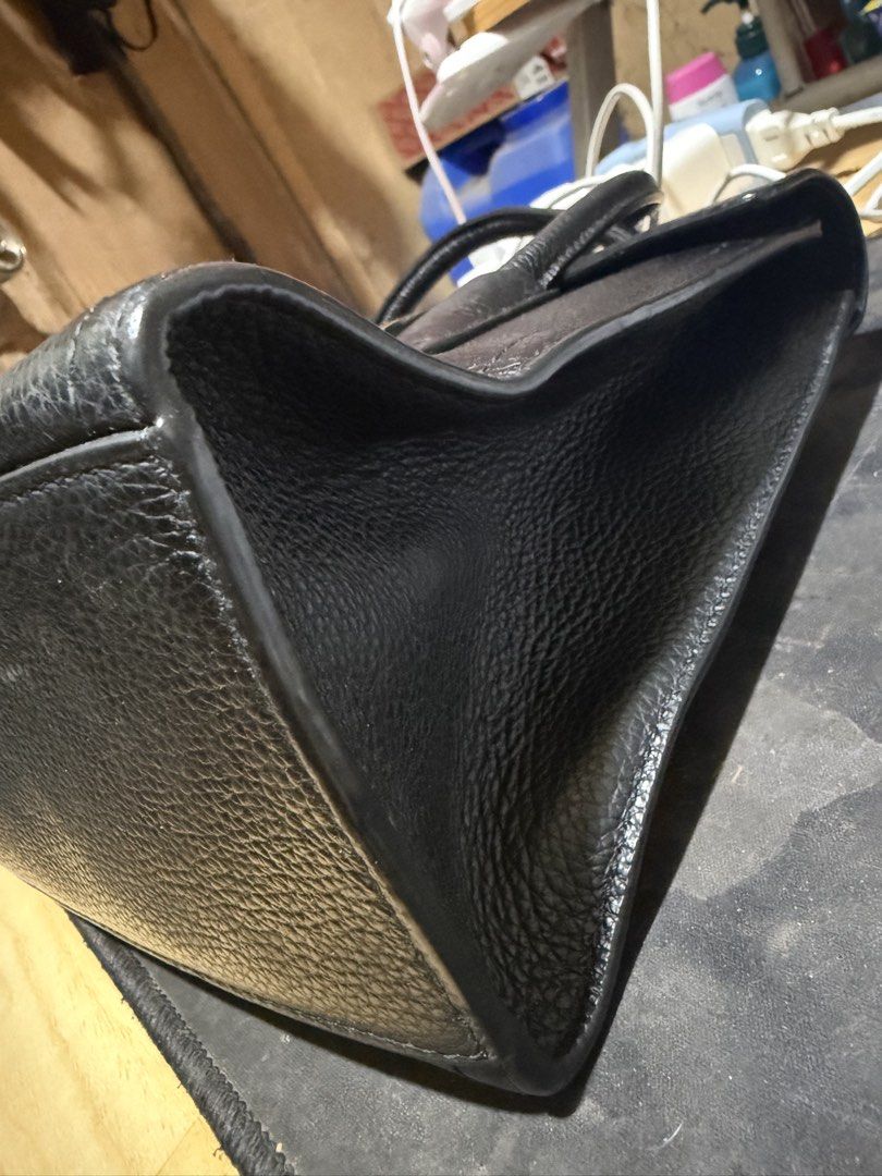 Furla Black Leather Top Handle Handbag (Category: Luxury Bags & Wallets) located in Opol. Submitted by great_finds_kollexion (Listing ID 1469881149, Image 2). Description: - Brand: Furla - Material: Premium black textured leather - Hardware: Elegant gold-tone closure - Features: Dual top handles, structured shape, sturdy base, and clean interior - Condition: Minimal signs of handling, excellent overall condition - Inclusions: Original brand bookl