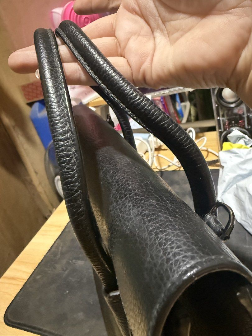 Furla Black Leather Top Handle Handbag (Category: Luxury Bags & Wallets) located in Opol. Submitted by great_finds_kollexion (Listing ID 1469881149, Image 3). Description: - Brand: Furla - Material: Premium black textured leather - Hardware: Elegant gold-tone closure - Features: Dual top handles, structured shape, sturdy base, and clean interior - Condition: Minimal signs of handling, excellent overall condition - Inclusions: Original brand bookl
