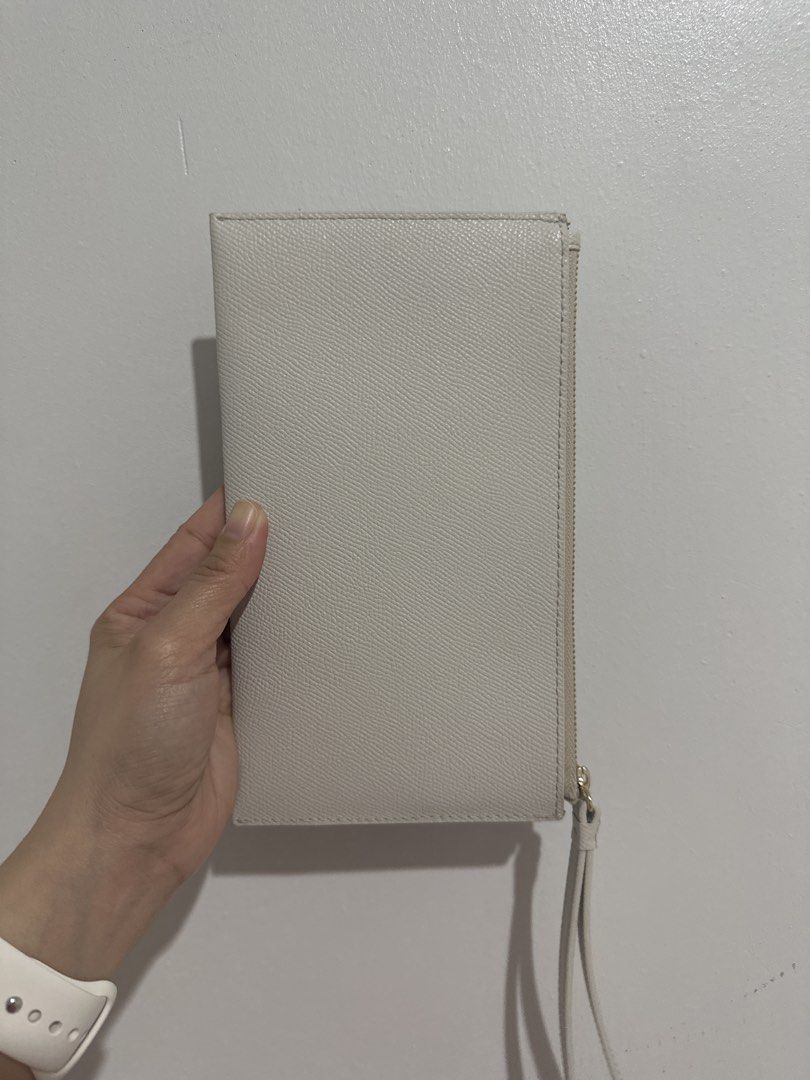 Furla Genuine Leather Wristlet (Category: Luxury Bags & Wallets) located in Cainta. Submitted by xyzasisa (Listing ID 1469946786, Image 3). Description: - Authentic Furla beige pouch in textured Saffiano-style leather - Comes with a convenient wrist strap for easy carrying - Secure zipper closure with elegant gold hardware - Clean fabric-lined interior featuring the genuine Furla leather tag - Slim profile, ideal for holding daily essentials - Sh