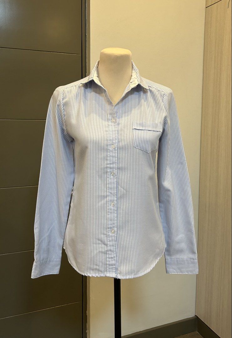 Gap Blue White Striped Button Down Shirt Medium (Category: Shirts) located in Manila. Submitted by _theverityshop (Listing ID 1469938215, Image 1). Description: - Style: Long sleeve button-down shirt - Pattern: Blue and white vertical stripes - Size: Medium (tag inside collar) - Features: Left chest pocket, classic collar with contrast white inner lining, and pleated back yoke detail - Condition: Great everyday top for work or casual outings.