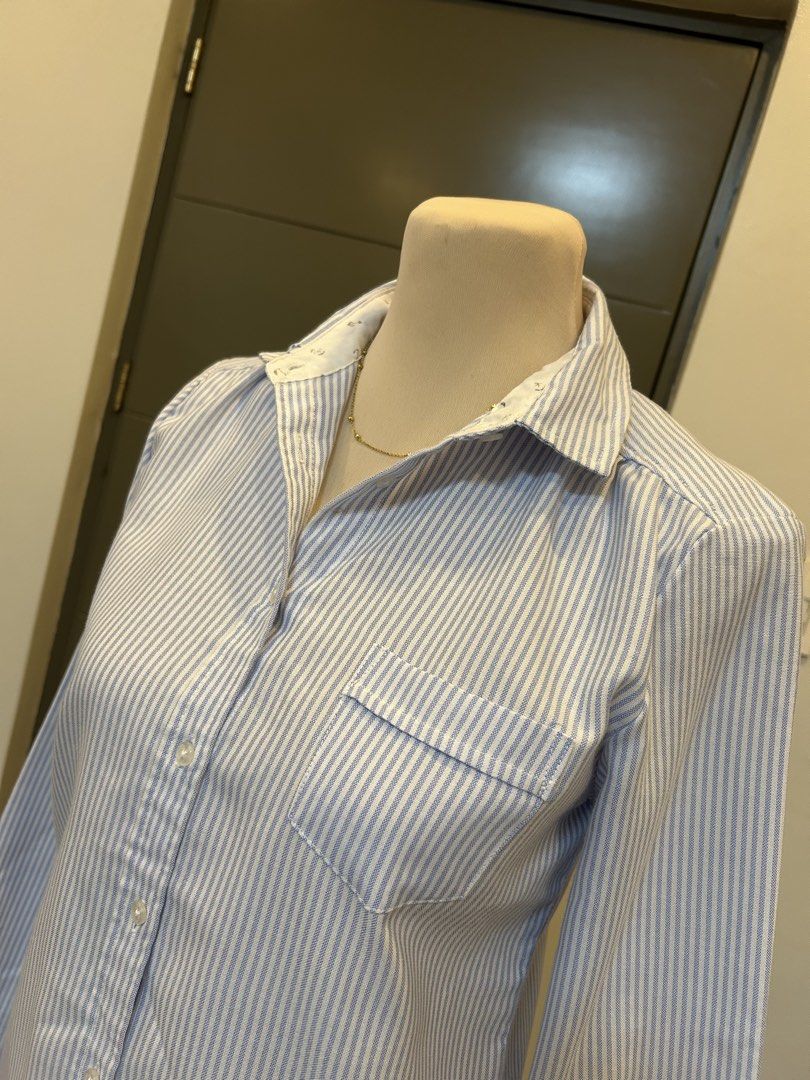 Gap Blue White Striped Button Down Shirt Medium (Category: Shirts) located in Manila. Submitted by _theverityshop (Listing ID 1469938215, Image 3). Description: - Style: Long sleeve button-down shirt - Pattern: Blue and white vertical stripes - Size: Medium (tag inside collar) - Features: Left chest pocket, classic collar with contrast white inner lining, and pleated back yoke detail - Condition: Great everyday top for work or casual outings.