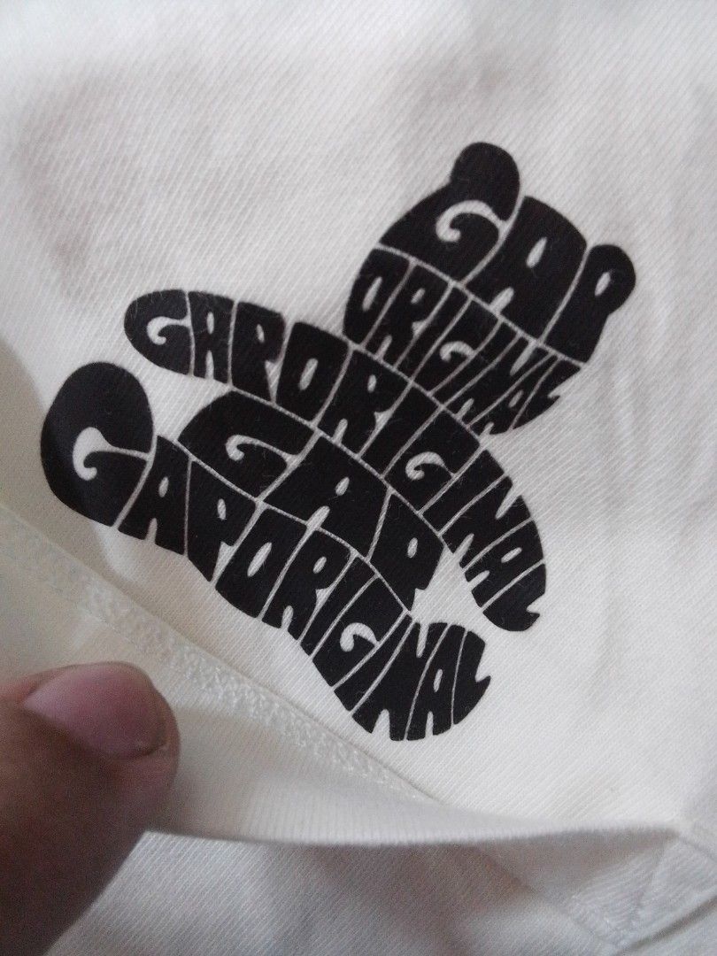 Gap Original Graphic White T-Shirt (Category: Shirts) located in Manila. Submitted by jctclthng_2026 (Listing ID 1469813737, Image 3). Description: - Brand: Gap - Color: White with black all-over typographic graphic - Design: Repeated 'Gap Original' stylized retro font into a best shaped logo - Fit & Style: Standard fit, short sleeves, crew neck - Material: Soft, lightweight, and breathable cotton - Condition: Minimal wear, need wash, no stains o