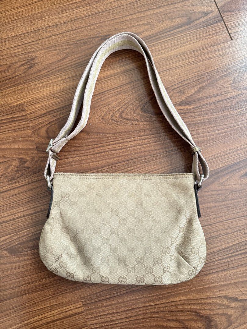 GG canvas web (Category: Cross-body Bags) located in Rizal. Submitted by thrifty.mom (Listing ID 1469859764, Image 2). Description: Beige Gucci monogram canvas shoulder bag. Adjustable striped canvas strap with pink and gold tones. Gold-tone metal Gucci logo plaque on the front. Top zipper closure. Compact size, everyday style. Measures 12in x 8in Thrift find only No guarantee No inclusions.