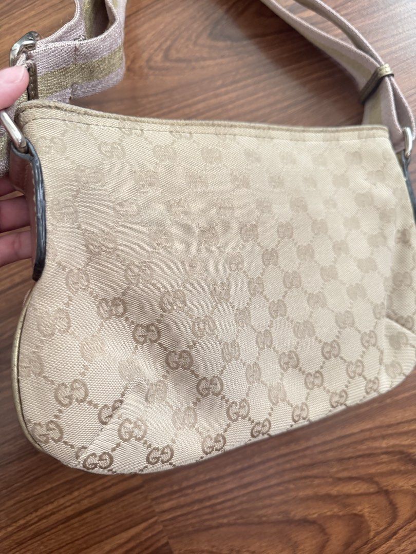 GG canvas web (Category: Cross-body Bags) located in Rizal. Submitted by thrifty.mom (Listing ID 1469859764, Image 3). Description: Beige Gucci monogram canvas shoulder bag. Adjustable striped canvas strap with pink and gold tones. Gold-tone metal Gucci logo plaque on the front. Top zipper closure. Compact size, everyday style. Measures 12in x 8in Thrift find only No guarantee No inclusions.