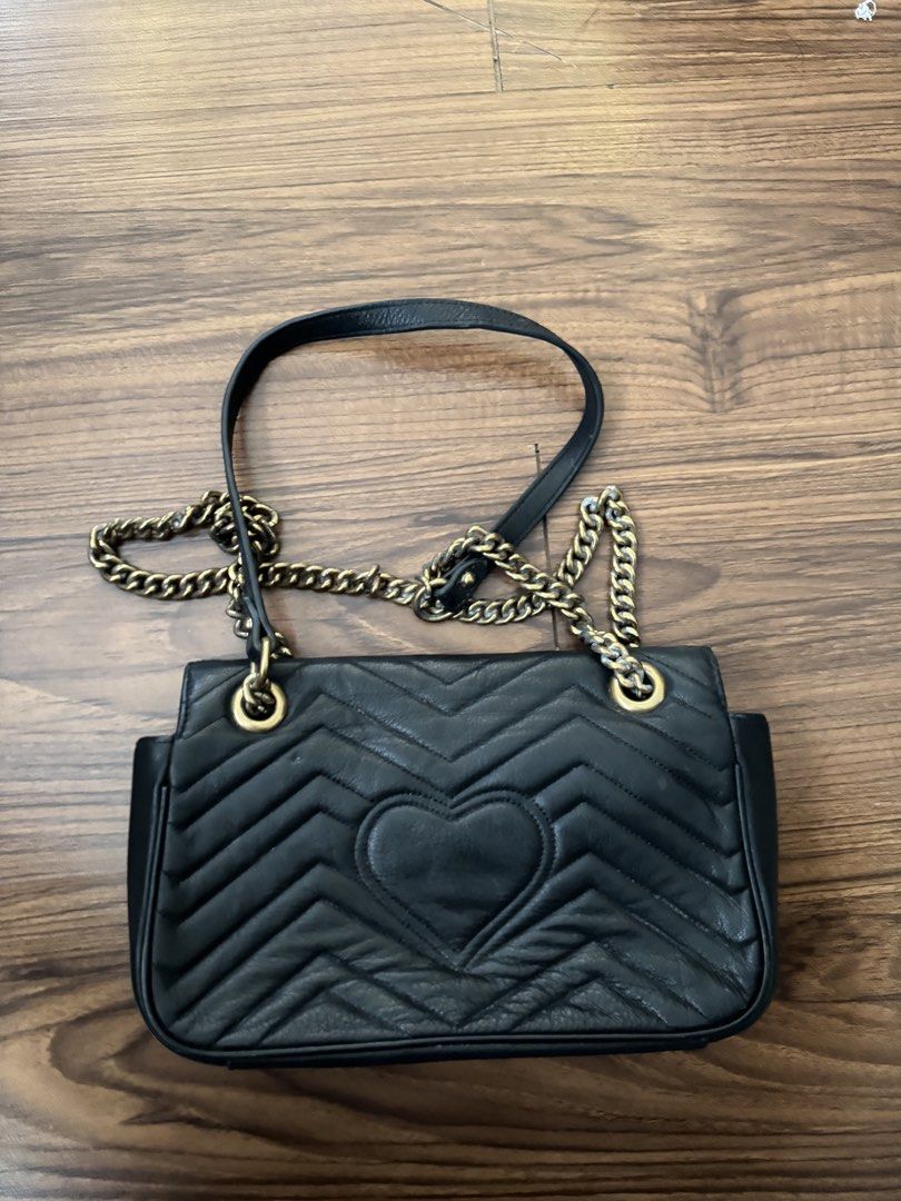 GG Marmont Matelasse Black (Category: Cross-body Bags) located in Rizal. Submitted by thrifty.mom (Listing ID 1469859393, Image 3). Description: - Brand: Gucci GG Marmont Shoulder Bag - Color: Classic Black - Material: Premium Leather with chevron quilting and back heart detail - Hardware: Antique brass with sliding chain strap and leather shoulder pad - Closure: Flap closure with iconic Interlocking G clasp Measurement 30cm Thrift find only No g