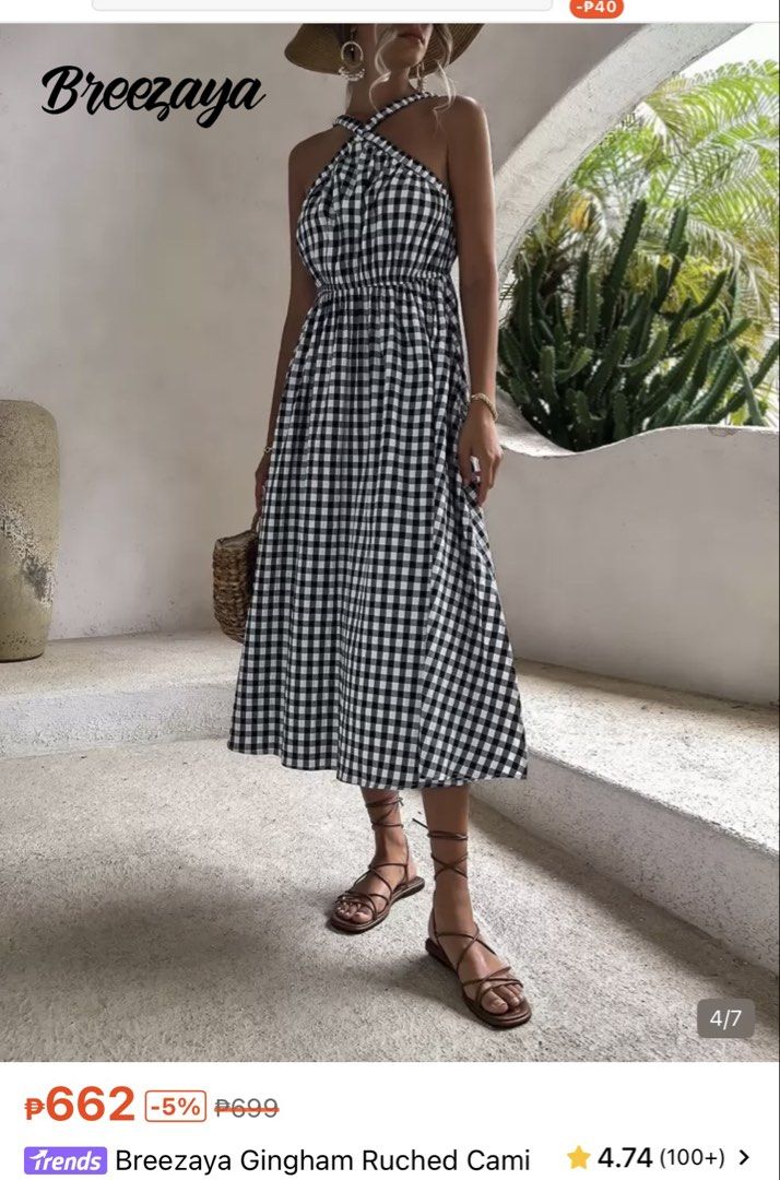 Gingham Cami Dress (Category: Dresses) located in Caloocan City. Submitted by everythingbagel67 (Listing ID 1469775400, Image 3). Description: - Brand: Breezaya - Pattern: Black and white gingham check - Design: Halter neckline with front cross straps and square back straps - Fit: Smocked elastic waist with a flowing A-line midi skirt - Material: Lightweight fabric, ideal for warm weather or beach trips - Condition: Clean condition.