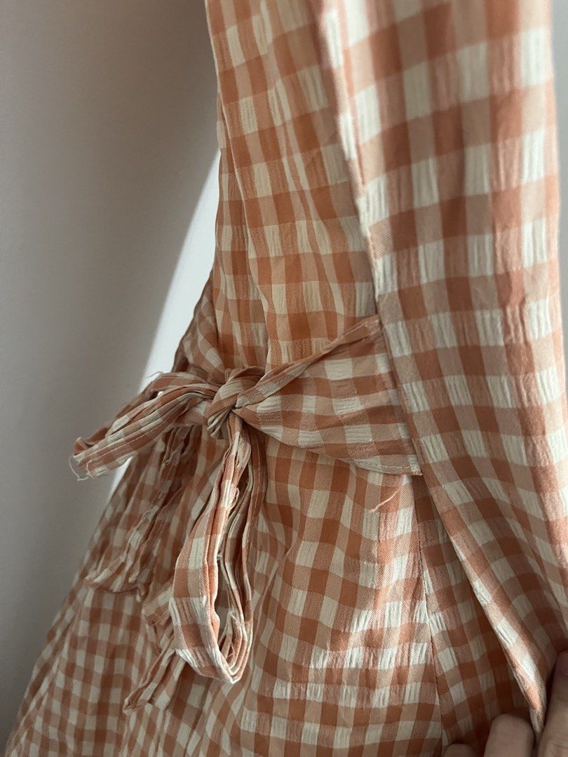 Gingham Maxi Dress (Category: Dresses) located in Lapu Lapu. Submitted by alexisdeclutters (Listing ID 1469788869, Image 2). Description: - Style: Orange & white gingham midi dress - Design: Sleeveless with a chic scoop neckline - Fit: Includes a matching fabric tie belt for an adjustable waist - Material: Lightweight and textured, perfect for warm weather - Length: Midi.