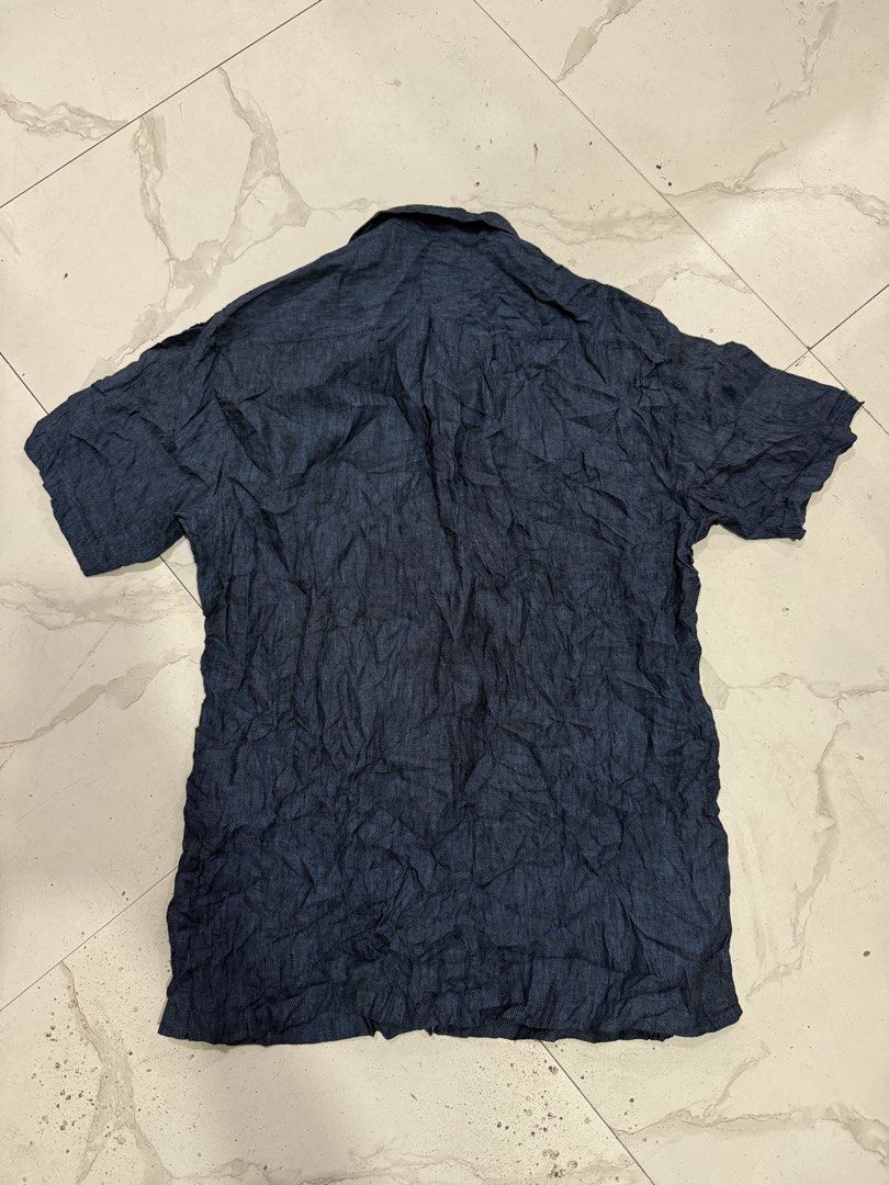 Givenchy Men Short Sleeve Button Down Shirt Size 95 (Category: Tshirts & Polo Shirts ) located in Bacolod City. Submitted by kitcarsonduff (Listing ID 1469887897, Image 2). Description: - Brand: Givenchy - Style: Men's short sleeve button-down shirt - Color & Pattern: Dark blue with a textured herringbone design - Size: 95 (Tag inside collar) - Details: Branded buttons with Givenchy text, left chest pocket - Origin: Made in Korea - Era: 2008 prod