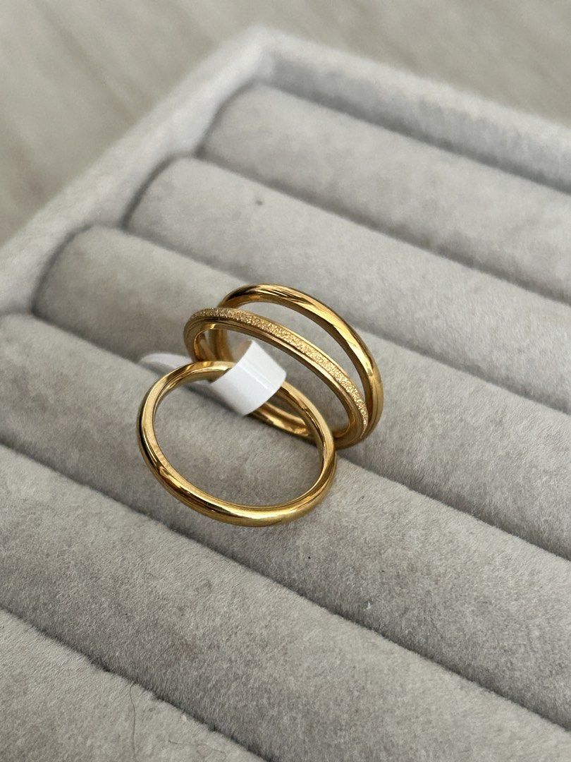 Gold-tone stacking rings set (Category: Rings) located in Manila. Submitted by elonlineshop (Listing ID 1469782318, Image 1). Description: - Item: Gold-tone stackable ring set - Quantity: Includes 3 distinct bands with smooth and textured finishes - Style: Simple and versatile daily jewelry piece -Stainless Steel -Sizes Available 6,7,8,9.