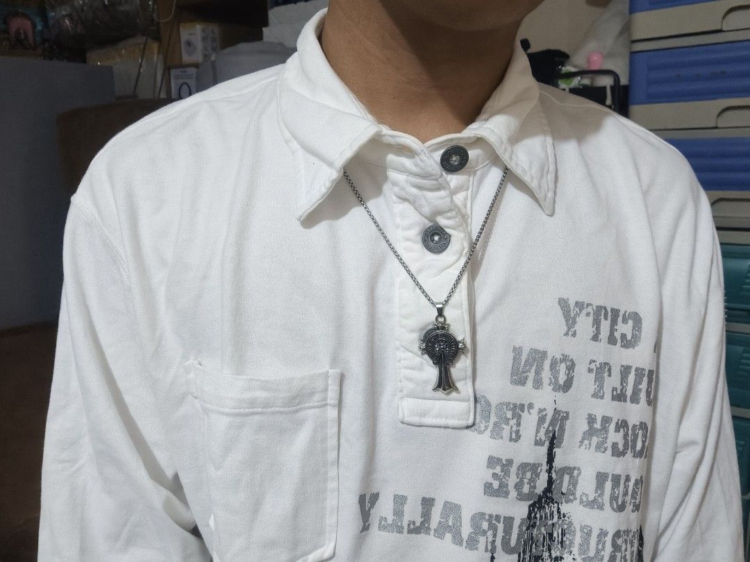 Graphic Button-Up Long Sleeve Shirt (Category: Tshirts & Polo Shirts ) located in Batangas. Submitted by okraf. (Listing ID 1467516041, Image 2). Description: - Style: White button-up long sleeve shirt with front pocket - Design: Vintage urban graphic print with text 'A city built on rock n roll would be structurally unsound' - Size: Fitted Large - Condition: No issues, just needs a wash - DM for more pictures and details.