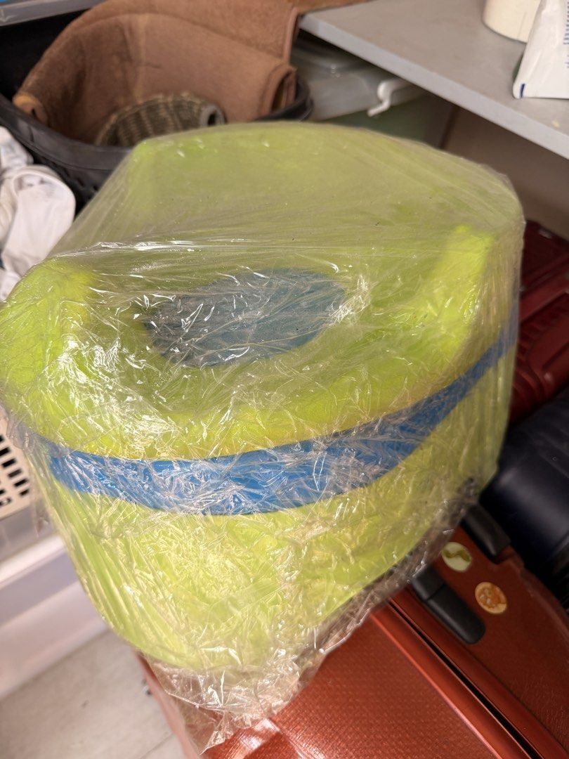 Green and blue plastic storage container wrapped in plastic (Category: Toilet Training) located in Manila. Submitted by officialrodz (Listing ID 1469765779, Image 1). Description: 1 Toilet seat adapter and 1 potty trainer - Color: Bright green with a blue stripe - Shape: Round with a solid build - Condition: Wrapped securely in clear plastic wrap for storage - Use: Perfect for organizing items around the house.