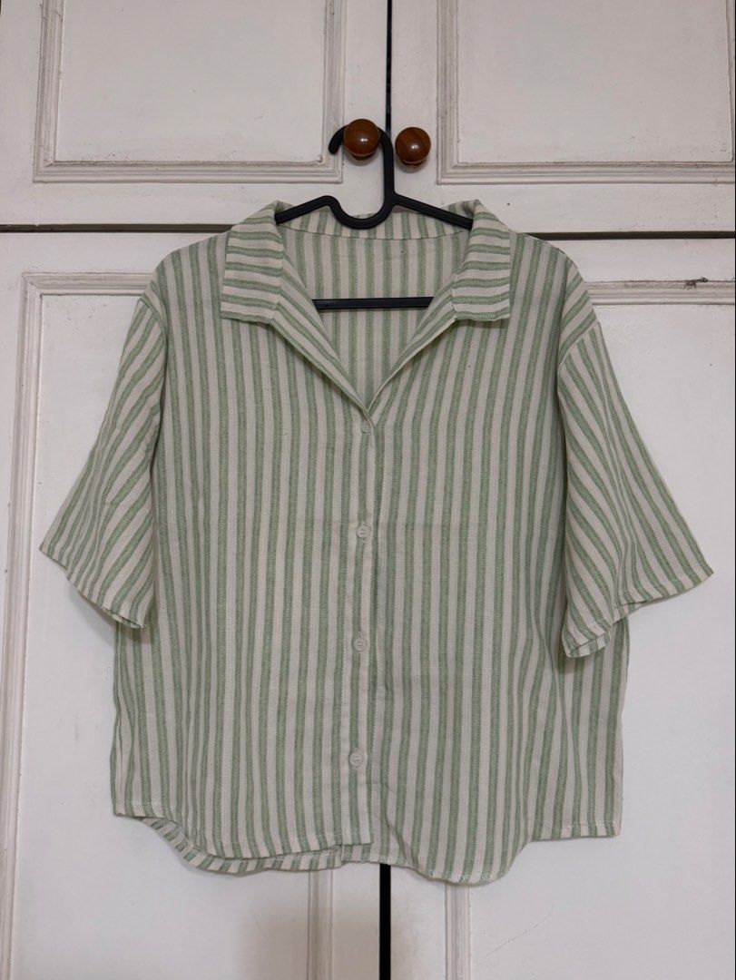 Green and white striped button-down collared shirt (Category: Shirts) located in Rizal. Submitted by rianaht (Listing ID 1469931655, Image 1). Description: - Green & white striped short sleeve shirt - Trendy camp collar with front buttons - Lightweight & textured fabric for ultimate comfort - Relaxed fit, ideal for warm weather - Excellent, clean condition with no flaws 🌸 RFS: Decluttering 🌸 Delivery only to be shouldered by the buyer. 🌸 Payme
