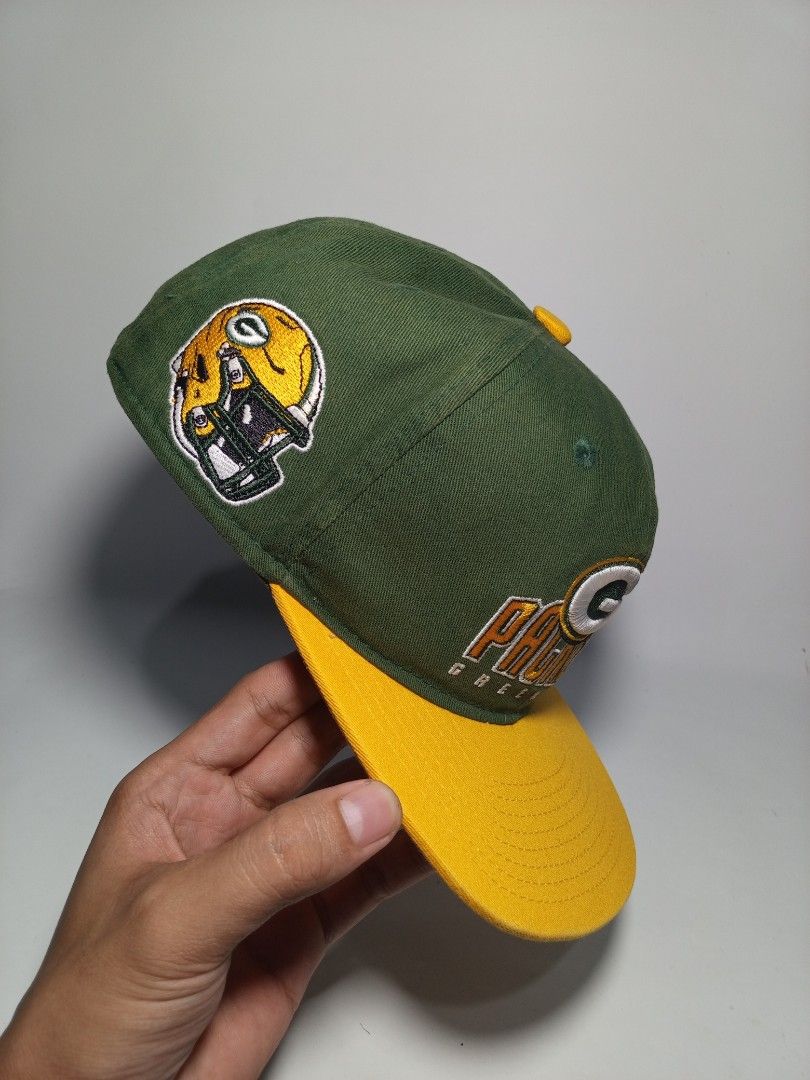Green Bay Packers NFL Team Apparel Snapback Cap (Category: Caps & Hats) located in Lucena. Submitted by sanera_23 (Listing ID 1469904914, Image 2). Description: -Youth Size - Authentic Green Bay Packers snapback cap in iconic green and yellow - Raised embroidery team logo on the front - Detailed helmet graphic on one side and team lettering on the other - Adjustable yellow snapback closure for a customized fit - Genuine NFL Team Apparel tag insid