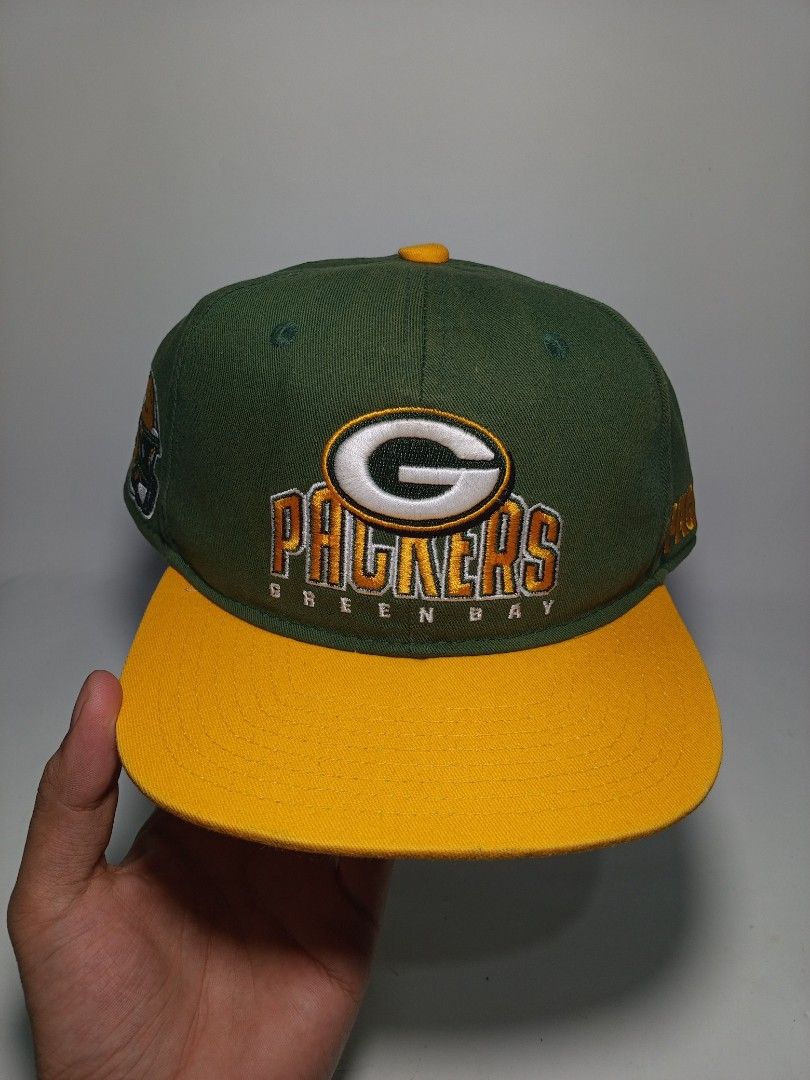 Green Bay Packers NFL Team Apparel Snapback Cap (Category: Caps & Hats) located in Lucena. Submitted by sanera_23 (Listing ID 1469904914, Image 1). Description: -Youth Size - Authentic Green Bay Packers snapback cap in iconic green and yellow - Raised embroidery team logo on the front - Detailed helmet graphic on one side and team lettering on the other - Adjustable yellow snapback closure for a customized fit - Genuine NFL Team Apparel tag insid