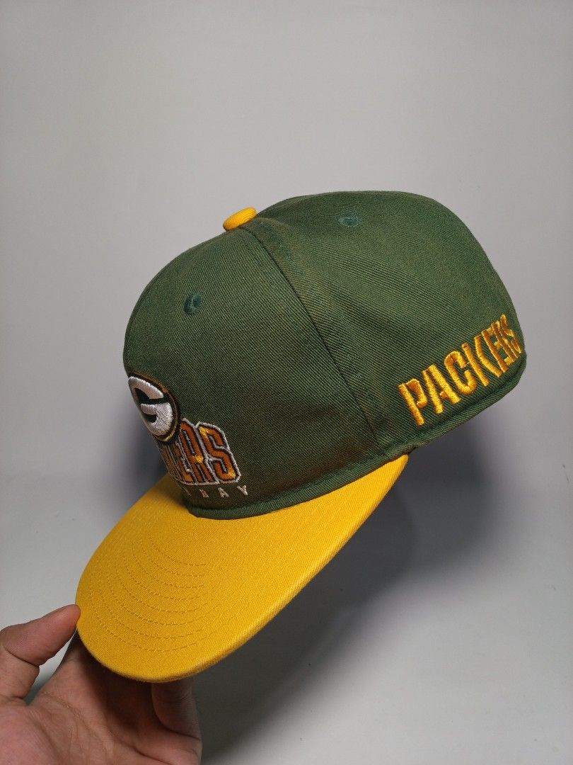 Green Bay Packers NFL Team Apparel Snapback Cap (Category: Caps & Hats) located in Lucena. Submitted by sanera_23 (Listing ID 1469904914, Image 3). Description: -Youth Size - Authentic Green Bay Packers snapback cap in iconic green and yellow - Raised embroidery team logo on the front - Detailed helmet graphic on one side and team lettering on the other - Adjustable yellow snapback closure for a customized fit - Genuine NFL Team Apparel tag insid