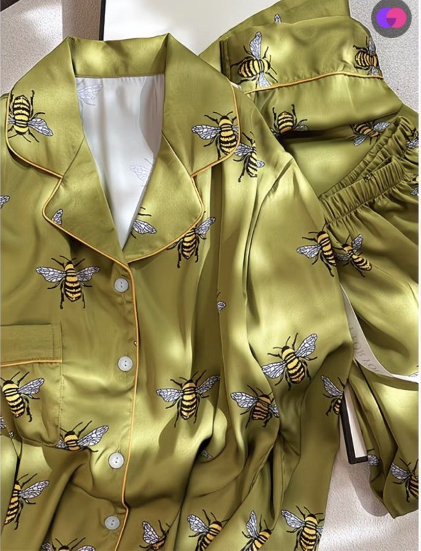 Green Satin Bee Print Pajama Set (Category: Undergarments & Loungewear) located in Quezon City. Submitted by the.happy.mommy (Listing ID 1469814953, Image 1). Description: - Material: Smooth, silky satin for ultimate comfort - Design: Green with a playful yellow and black bee print - Top: Long sleeve, button-down with a chic lapel collar - Bottoms: Comfortable matching pants with an elastic waistband - Condition: Brand new.