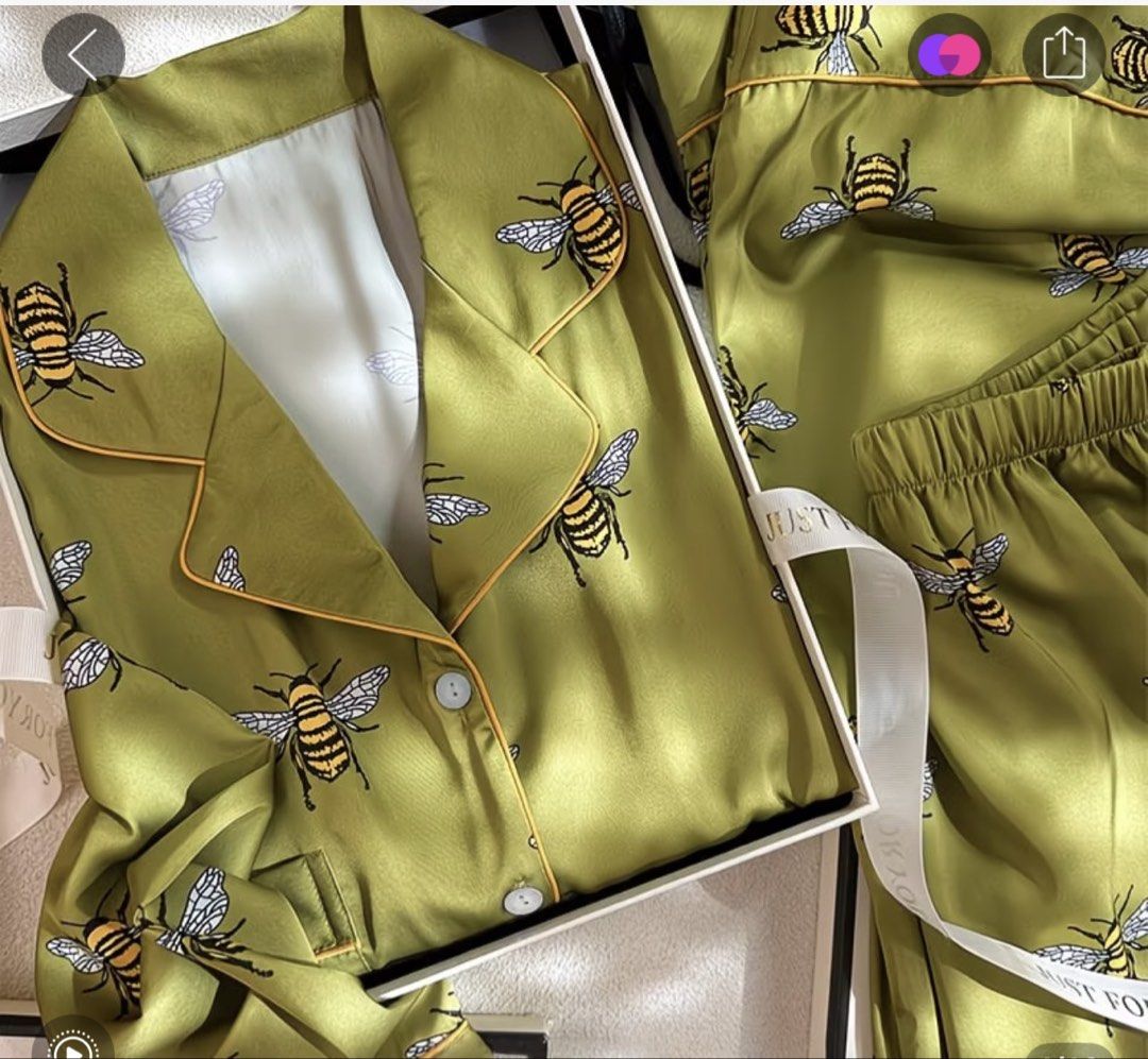 Green Satin Bee Print Pajama Set (Category: Undergarments & Loungewear) located in Quezon City. Submitted by the.happy.mommy (Listing ID 1469814953, Image 2). Description: - Material: Smooth, silky satin for ultimate comfort - Design: Green with a playful yellow and black bee print - Top: Long sleeve, button-down with a chic lapel collar - Bottoms: Comfortable matching pants with an elastic waistband - Condition: Brand new.
