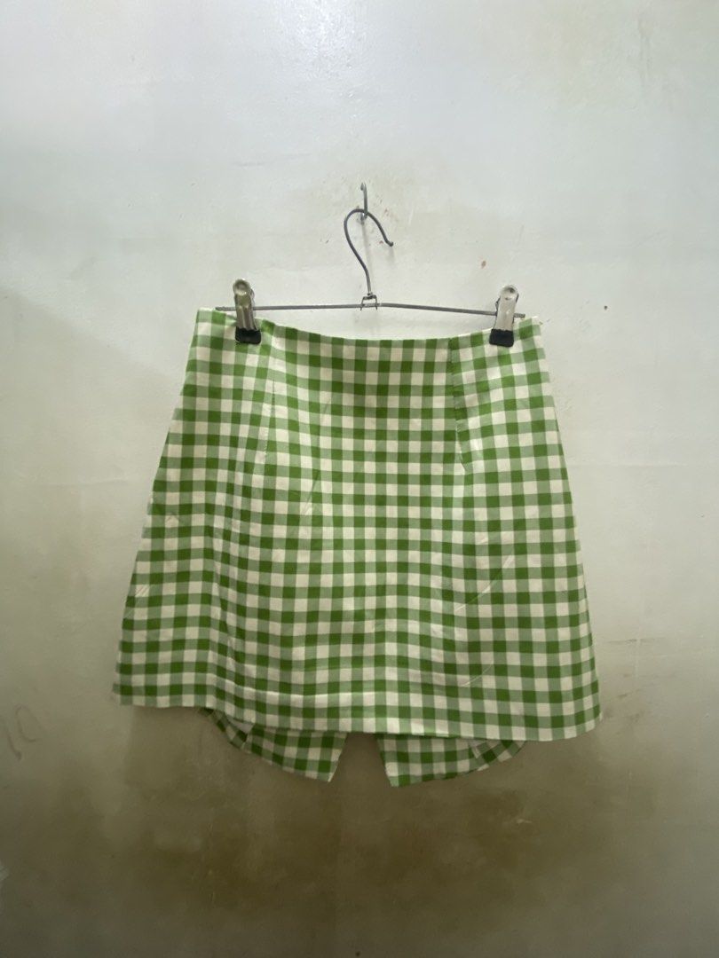 Green White Gingham Checkered Asymmetrical Skort (Category: Skirts) located in Manila. Submitted by yannaapril (Listing ID 1469801574, Image 3). Description: - Color/Pattern: Green and white gingham checkered - Design: Asymmetrical front overlay with three green buttons - Fit: Fitted waist with structured fabric - Comfort: Skirt look with shorts underneath - Occasion: Great for casual days out or picnics.