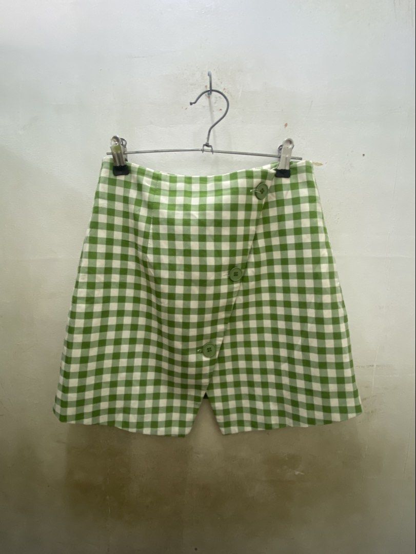 Green White Gingham Checkered Asymmetrical Skort (Category: Skirts) located in Manila. Submitted by yannaapril (Listing ID 1469801574, Image 1). Description: - Color/Pattern: Green and white gingham checkered - Design: Asymmetrical front overlay with three green buttons - Fit: Fitted waist with structured fabric - Comfort: Skirt look with shorts underneath - Occasion: Great for casual days out or picnics.