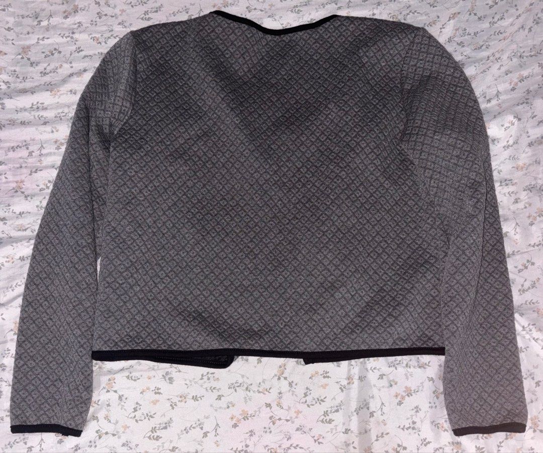 Grey Quilted Pattern Open Front Jacket with Pockets (Category: Coats, Jackets and Outerwear) located in Davao. Submitted by dvnzaii (Listing ID 1469875531, Image 2). Description: - Style: Open front grey jacket - Pattern: Textured quilted all over - Details: Black trim along neckline, placket, and hem - Pockets: Two functional front pockets with secure zipper closures - Condition: Clean inside and out.
