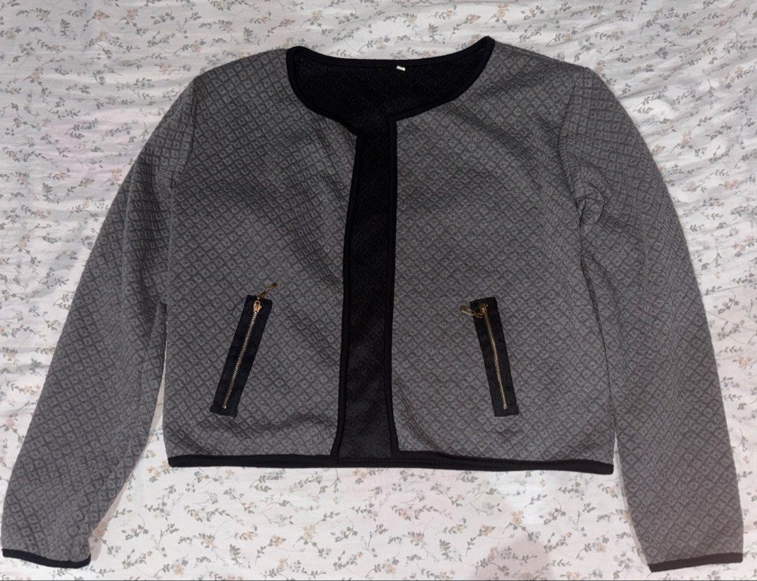 Grey Quilted Pattern Open Front Jacket with Pockets (Category: Coats, Jackets and Outerwear) located in Davao. Submitted by dvnzaii (Listing ID 1469875531, Image 1). Description: - Style: Open front grey jacket - Pattern: Textured quilted all over - Details: Black trim along neckline, placket, and hem - Pockets: Two functional front pockets with secure zipper closures - Condition: Clean inside and out.
