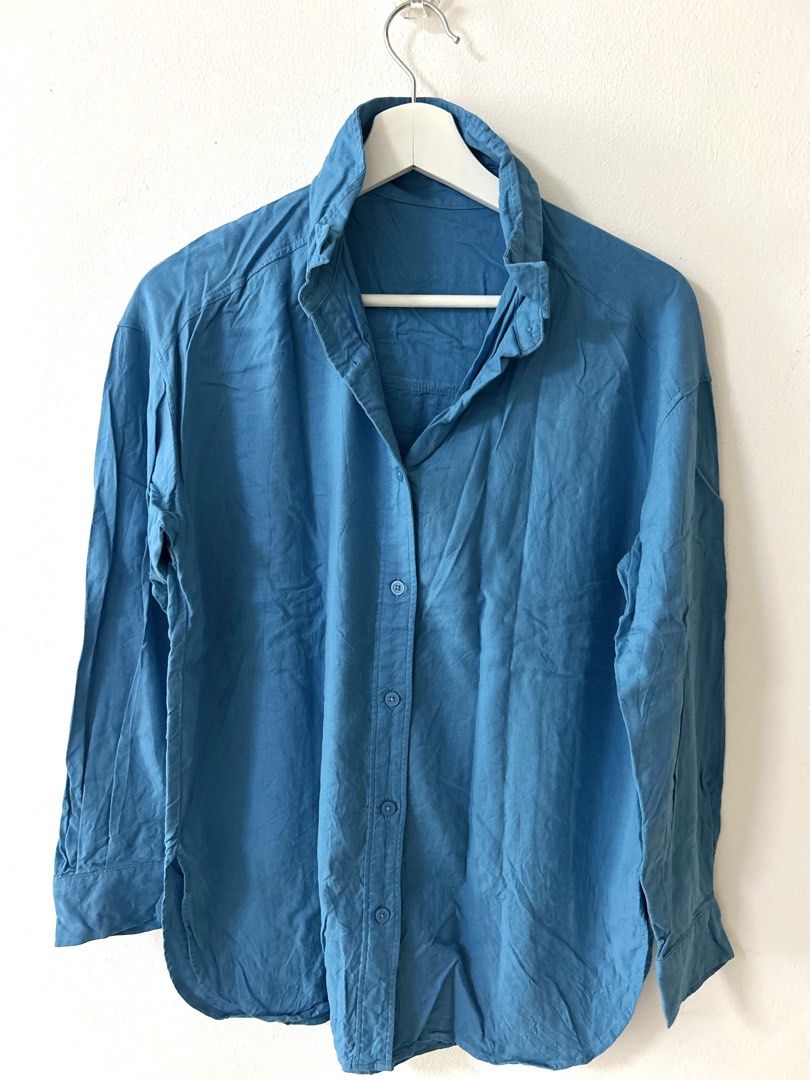 GU Blue Long Sleeve Button-Up Shirt (Category: Longsleeves) located in Manila. Submitted by isabelle_1104 (Listing ID 1469944107, Image 1). Description: - Color: Solid blue - Fit: Relaxed fit with classic collar and curved hem - Closure: Front button-up with matching buttons - Material: Lightweight woven fabric - Versatility: Perfect for casual outings or layering - Condition: Brand new / Excellent quality.