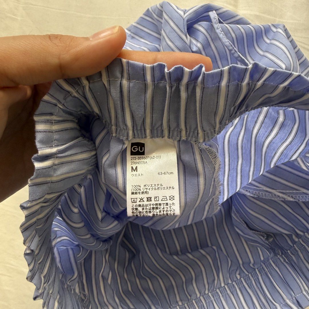 GU Blue Striped Drawstring Shorts Size M (Category: Shorts) located in Pasig City. Submitted by notshynotmeee (Listing ID 1469809132, Image 2). Description: - Brand/Style: GU striped shorts in blue and white - Size: M (fits waist 63-67 cm) - Material: 100% recycled polyester, lightweight fabric - Features: Elastic waistband with adjustable drawstring tie - Condition/Use: Easy pull-on style, perfect for lounging or casual days.