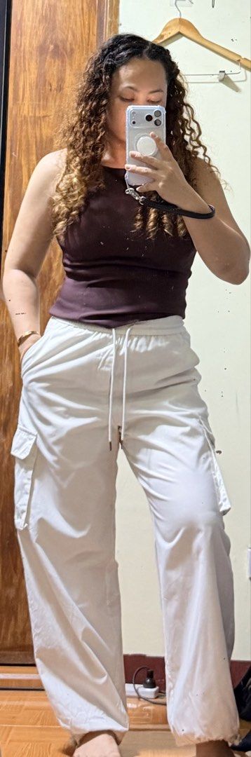 GU White Cargo Parachute Pants Size M (Category: Other Bottoms) located in Paete. Submitted by skydruemadison (Listing ID 1469872763, Image 2). Description: - Brand/Model: GU White Parachute Pants - Size: M - Waist: Elastic waistband with adjustable drawstring - Pockets: Stylish side cargo pockets - Hem: Adjustable toggles at the ankles - Fit: Relaxed fit through the legs with a fully lined interior.