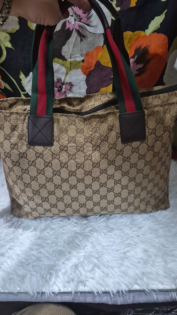 Gucci GG Canvas Web Stripe Tote Bag (Category: Tote Bags) located in Baguio. Submitted by jhaz_bags (Listing ID 1469900645, Image 3). Description: - Authentic Gucci GG monogram canvas tote bag - Classic brown leather trim and base - Iconic green and red web stripe handles with dark leather attachments - Secure top zipper closure - Brown fabric-lined interior with a convenient zipper pocket - Spacious design, perfect for everyday use - Condition n