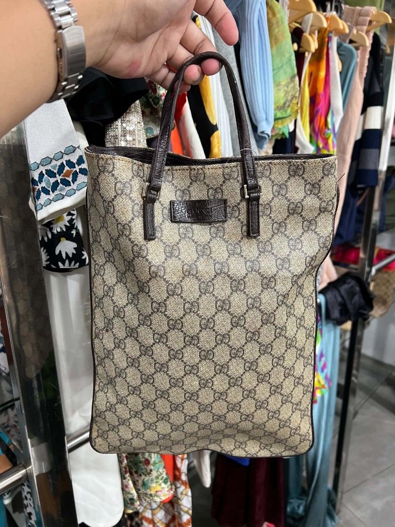Gucci GG Monogram Canvas Tote Bag (Category: Luxury Bags & Wallets) located in Urdaneta. Submitted by jayceegarage (Listing ID 1469903906, Image 1). Description: - 100% Authentic Gucci monogram canvas tote in brown and beige - Premium dark brown textured leather trim with front logo patch - Secure magnetic snap button closure - Compact vertical rectangular shape for effortless everyday use - Double top handles for comfortable carrying.