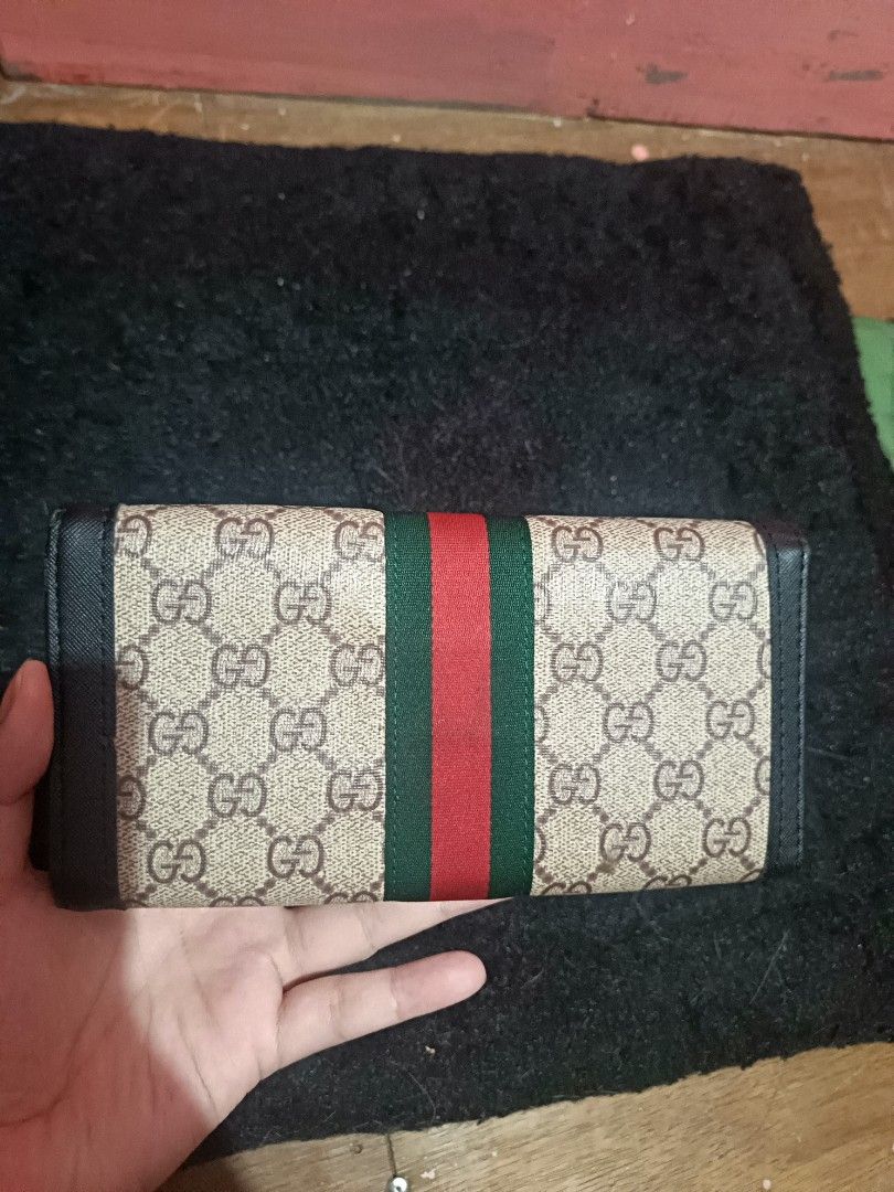 Gucci GG Supreme Canvas Tri-fold Long Wallet (Category: Luxury Bags & Wallets) located in Manila. Submitted by mikashanggg (Listing ID 1469883722, Image 2). Description: - Authentic Gucci long wallet in classic beige GG supreme canvas - Features the signature green and red web stripe with gold-tone GG hardware - Premium black leather trim and durable interior lining - Secure snap button closure - Excellent storage: multiple card slots, cash compa