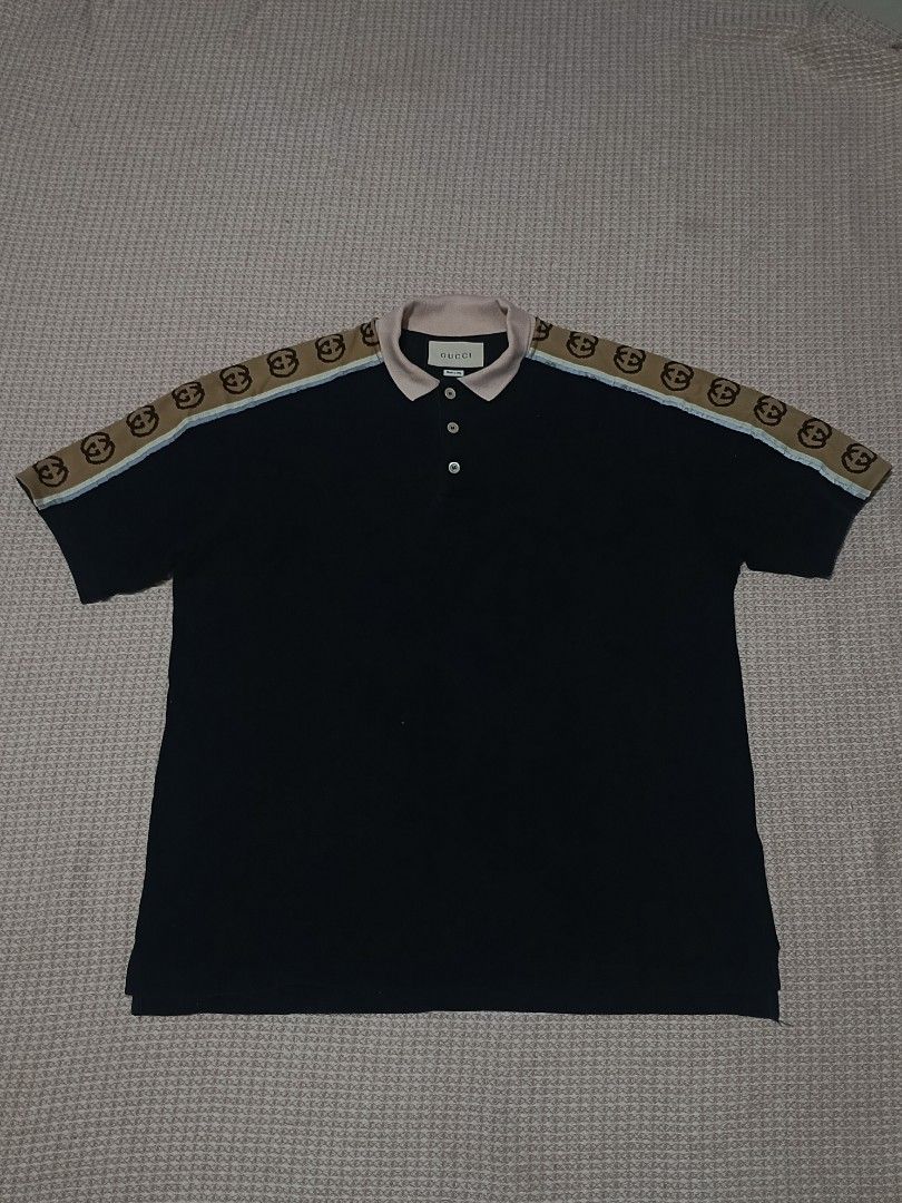Gucci Interlocking G Polo Shirt (Category: Tshirts & Polo Shirts ) located in Dipolog. Submitted by just_thriftfinds (Listing ID 1469914608, Image 1). Description: - Brand: Gucci - Item: Polo Shirt - Color: Black with contrast pink collar and light blue stripe accents - Size: L - Dimes: 22/28 - Material: Cotton blend, Made in Italy - Design: Three-button placket and signature interlocking G branded tape running across shoulders and sleeves - Cond