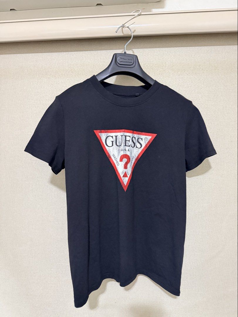 Guess Black T-Shirt with Triangle Logo Size M (Category: Shirts) located in Cavite. Submitted by mgd.blessed (Listing ID 1469910680, Image 1). Description: - Brand: Guess - Color: Black with iconic red and silver triangle logo - Size: Medium (M) - Material: Comfortable cotton - Origin: Made in Bangladesh - Style: Crew neck, short sleeves, easy to pair with jeans or shorts.