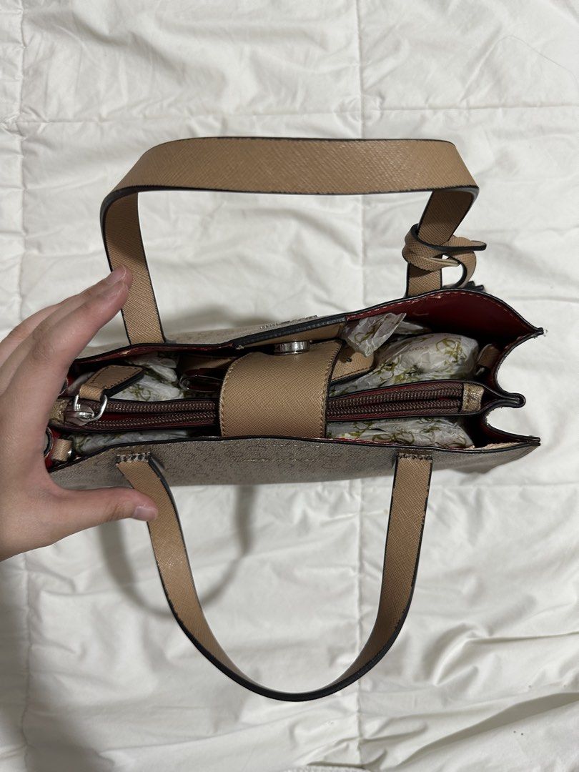 Guess Brown Top Handle / Crossbody Bag (Category: Cross-body Bags) located in Quezon City. Submitted by by.apreloved (Listing ID 1469913159, Image 3). Description: - leather inside has started to peel, but canvas is still in great condition - barely used, peeling only happened due to its age - authentic from subic outlet years ago - comes with crossbody strap and original dustbag - message for more photos (serious buyers only) - mop: gcash.
