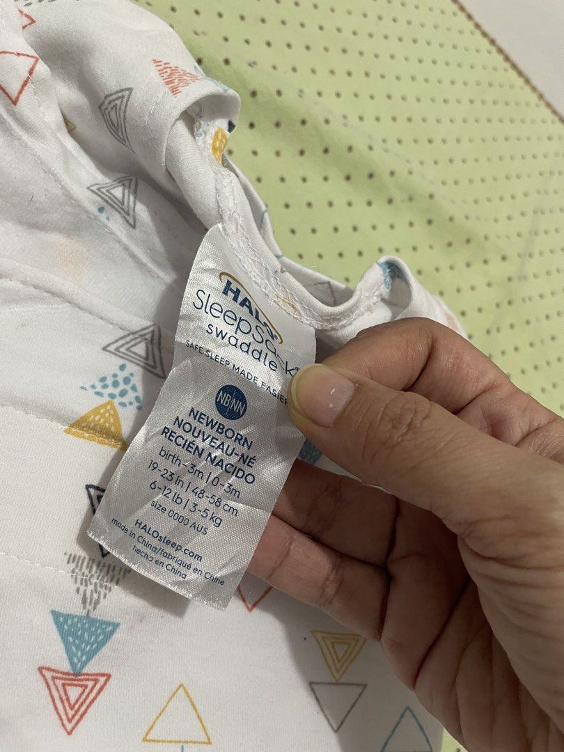 HALO SleepSack Swaddle Newborn Triangle Print (Category: Babies & Kids Fashion) located in San Jose del Monte. Submitted by momma_buys (Listing ID 1469830718, Image 2). Description: - Brand: HALO SleepSack Swaddle - Size: Newborn (Fits birth to 3 months, 6-12 lbs) - Design: Colorful triangle pattern on white background - Material: 100% breathable cotton for safe and cozy sleep - Features: Adjustable wrap wings for a secure fit and inverted zipper