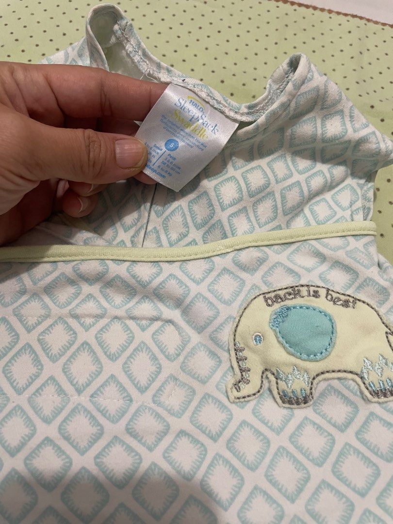 HALO SleepSack Swaddle Size S Elephant (Category: Babies & Kids Fashion) located in San Jose del Monte. Submitted by momma_buys (Listing ID 1469830506, Image 2). Description: - Brand: HALO SleepSack Swaddle - Size: Small (0-6 months, fits 13-18 lbs) - Design: Blue and white geometric diamond pattern with cute elephant 'Back is Best' applique - Features: Easy zipper design and adjustable wrap wings - Material: Soft 100% cotton for a cozy and secur