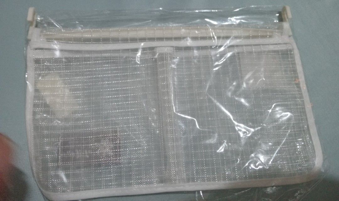 hanging storage bag organizer (Category: Food Organization & Storage) located in Makati City. Submitted by YSL80022 (Listing ID 1469887648, Image 3). Description: - Color: White with grid pattern - Features: Secure zipper closure, 2 handy front pockets, and top plastic hanging clips - Material: Durable mesh fabric - Condition: Brand new, still in original clear plastic packaging - Perfect for organizing small items, cosmetics, or accessories RFS: