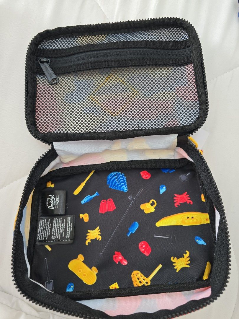 Herschel x LEGO Pencil Case Multicolour (Category: Stationery & School Supplies) located in San Juan City. Submitted by mypurpleattic (Listing ID 1469840254, Image 3). Description: Scavenger Hunt Bricks colorway, from the limited-edition Herschel x LEGO® collection - Brand new with original hang tag attached - Authentic Herschel Supply Co. pouch in a colorful LEGO block pattern - Features a bright yellow rubberized LEGO stud patch on the front - 