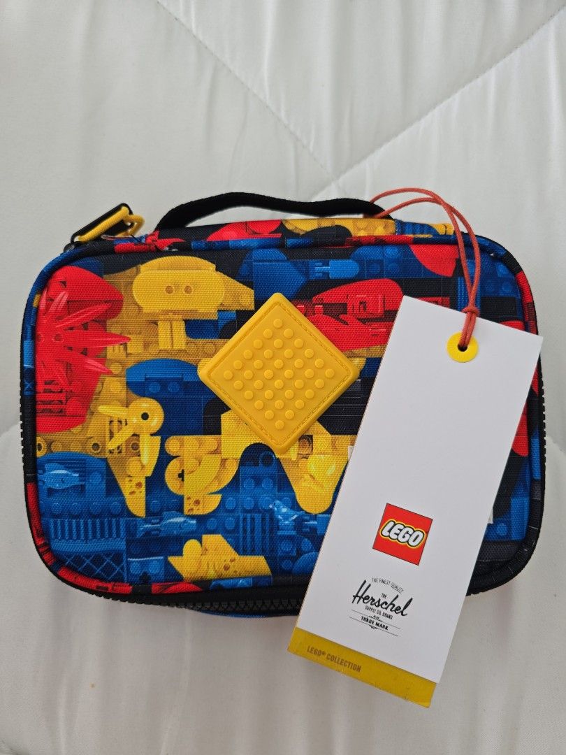 Herschel x LEGO Pencil Case Multicolour (Category: Stationery & School Supplies) located in San Juan City. Submitted by mypurpleattic (Listing ID 1469840254, Image 1). Description: Scavenger Hunt Bricks colorway, from the limited-edition Herschel x LEGO® collection - Brand new with original hang tag attached - Authentic Herschel Supply Co. pouch in a colorful LEGO block pattern - Features a bright yellow rubberized LEGO stud patch on the front - 