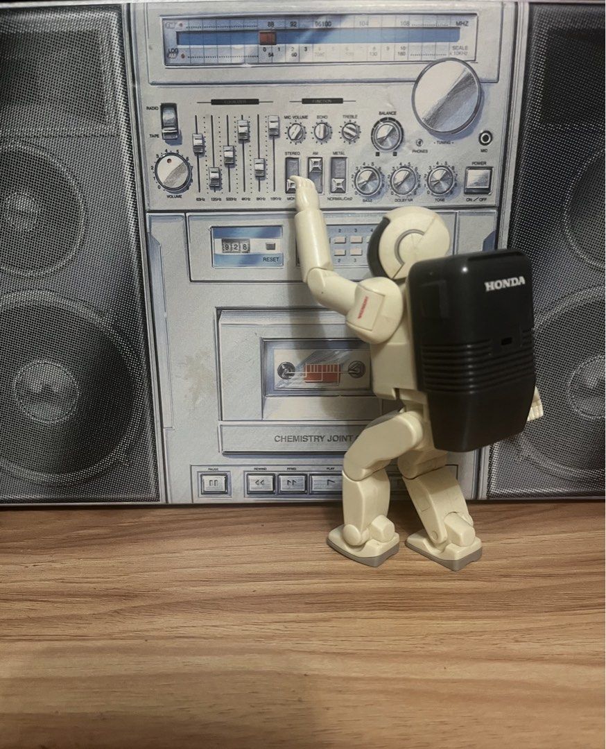 Honda Asimo Robot Action Figure (Category: Figurines & Statues) located in Quezon City. Submitted by ceejay1114 (Listing ID 1469914453, Image 2). Description: - Official Honda Asimo collectible figure - Features cream and grey plastic body with dark visor and branded black backpack - Fully articulated arms and legs, stands independently - Comes with a cool boombox backdrop for display - Ideal addition for tech enthusiasts and robot collectors - T