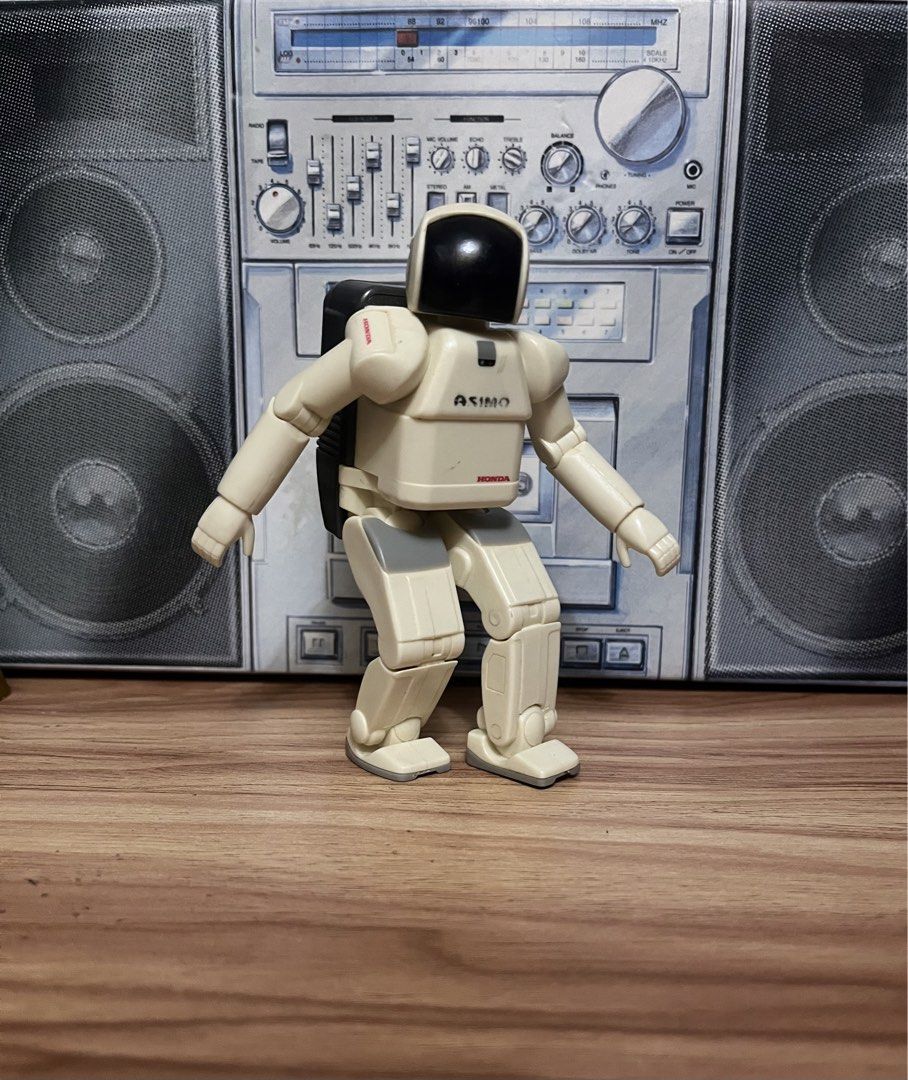 Honda Asimo Robot Action Figure (Category: Figurines & Statues) located in Quezon City. Submitted by ceejay1114 (Listing ID 1469914453, Image 1). Description: - Official Honda Asimo collectible figure - Features cream and grey plastic body with dark visor and branded black backpack - Fully articulated arms and legs, stands independently - Comes with a cool boombox backdrop for display - Ideal addition for tech enthusiasts and robot collectors - T