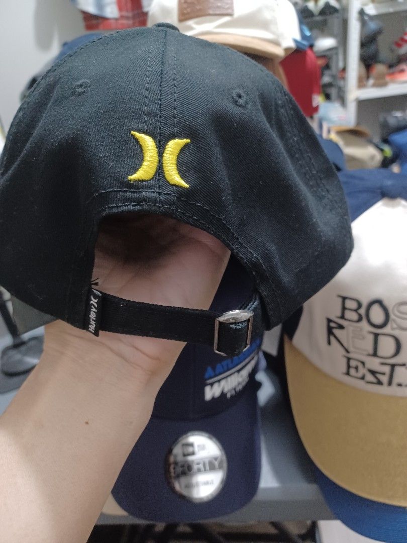 Hurley Black Cap with Diamond Logo (Category: Caps & Hats) located in Mandaluyong City. Submitted by usamenfashionhaul (Listing ID 1469917218, Image 2). Description: - Color: Classic black - Design: Diamond patch with "Surf & Enjoy HURLEY SINCE 1999" text on the front - Details: Iconic yellow Hurley icon embroidered on the back - Fit: Adjustable metal strap closure with Hurley branding on the tab - Quality: Clean fabric with solid stitching.